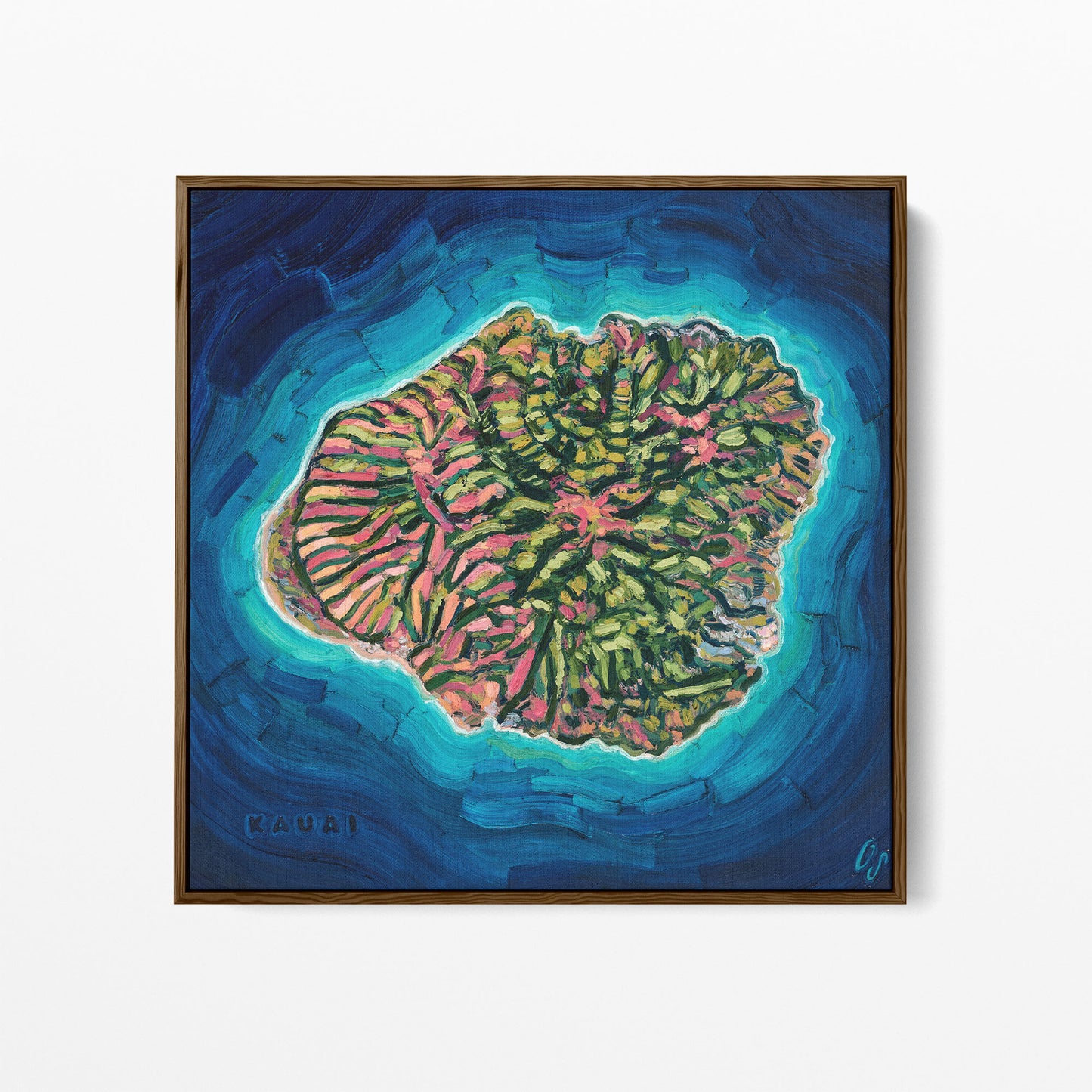 A framed square painting of a coral reef island surrounded by deep blue ocean water, with green, pink, and turquoise tones. The painting is housed in a dark wood frame and displayed against a clean white background.